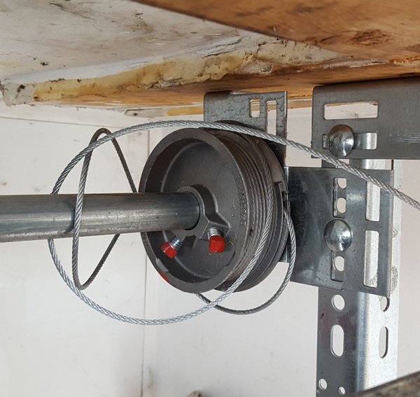 Broken garage door spring pulley mechanism